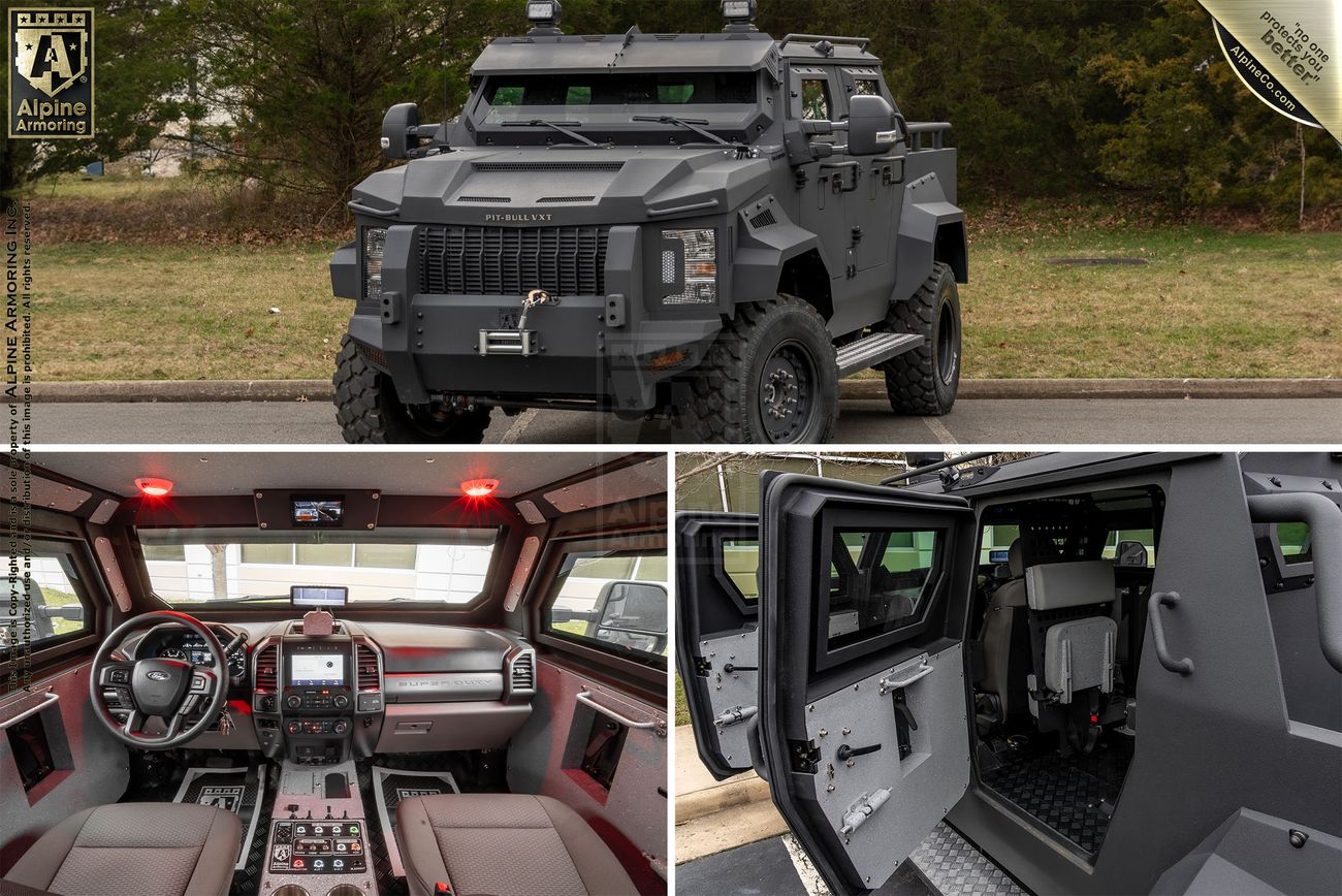 Close-up view of an Pit-Bull VXT's side, showing the heavy-duty door with a small window and latch mechanism. Trees are visible in the background.